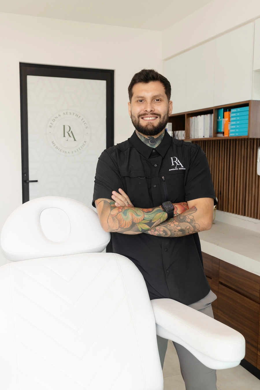 Member of the Redna Aesthetics team standing beside a treatment chair