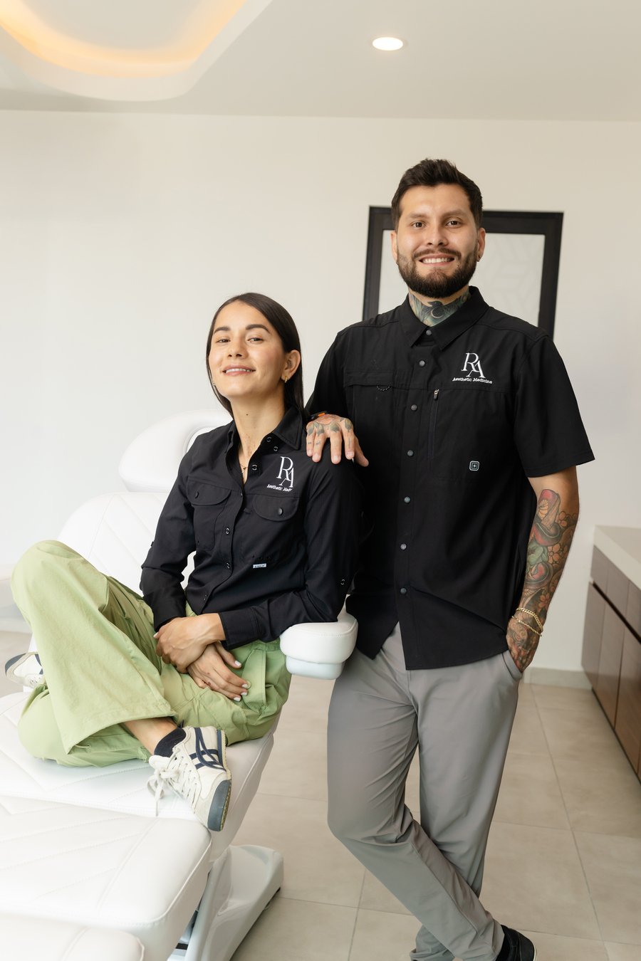 Two members of the Redna Aesthetics team standing together in the clinic