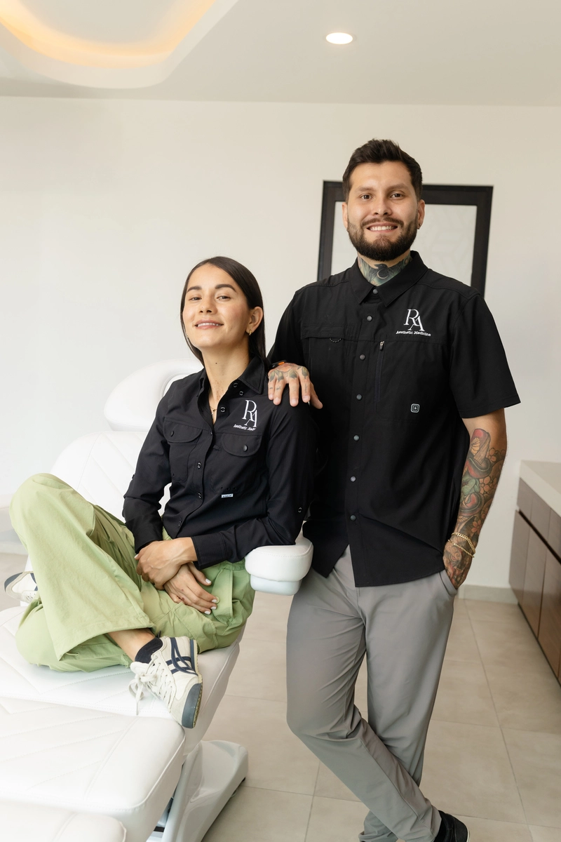 Two members of the Redna Aesthetics team standing together in the clinic